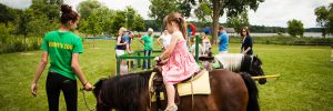 girl riding horse at Long Lake community event